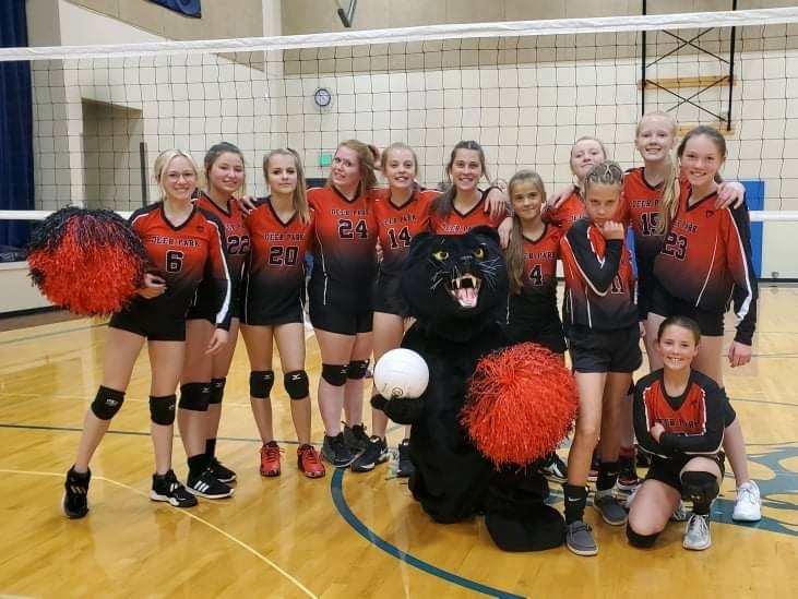 girls' volleyball team and mascot