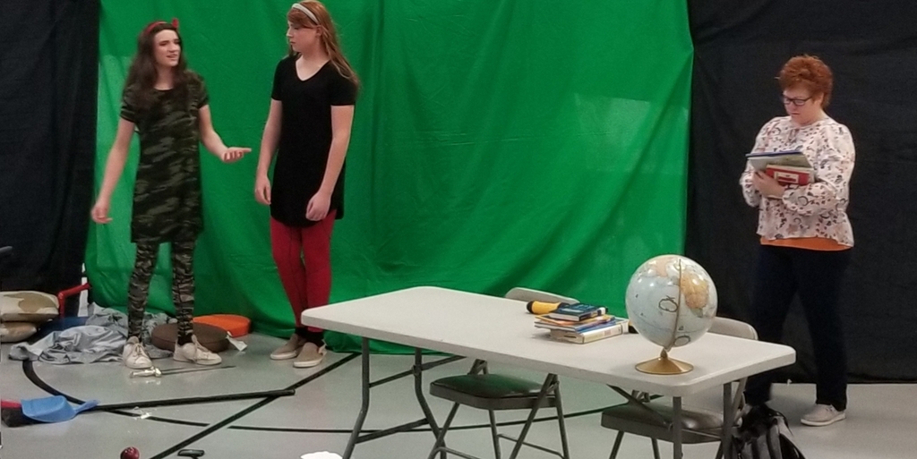 three people standing near a table