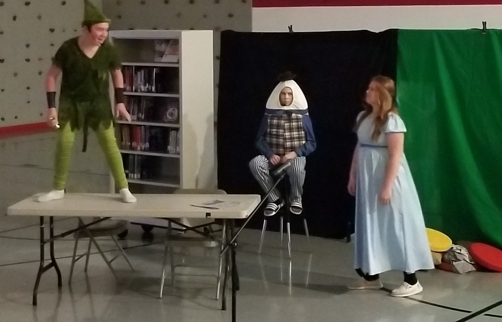 one person on a table two standing nearby