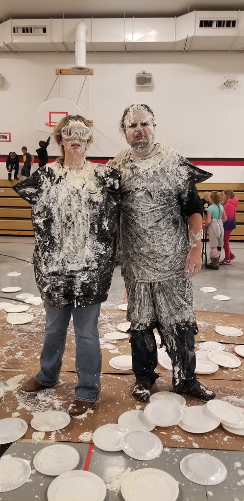 a man and a woman covered in whipped cream
